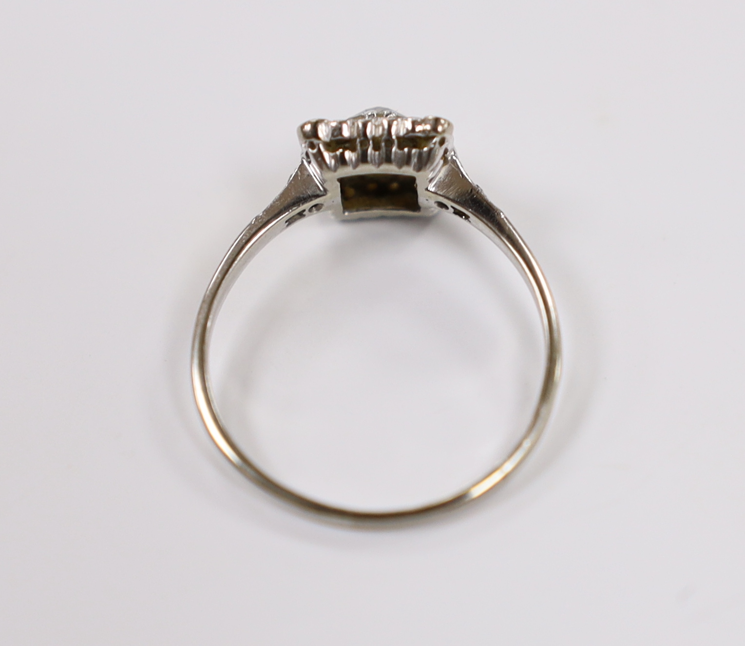 A 1940's 18ct white metal and single stone diamond ring, with diamond set square border and diamond set shoulders, size Q/R, gross weight 2.7 grams